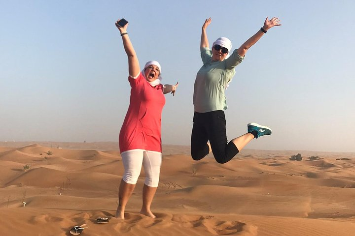Experience the joy of jumping across the stunning red dunes embracing the freedom of adventure in the desert. Capture unforgettable moments while exploring the heart of Dubai’s landscape.